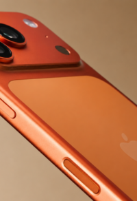 Close-up of an iPhone 18 Pro Max with a sleek orange finish, showcasing the triple-camera setup and Apple logo.